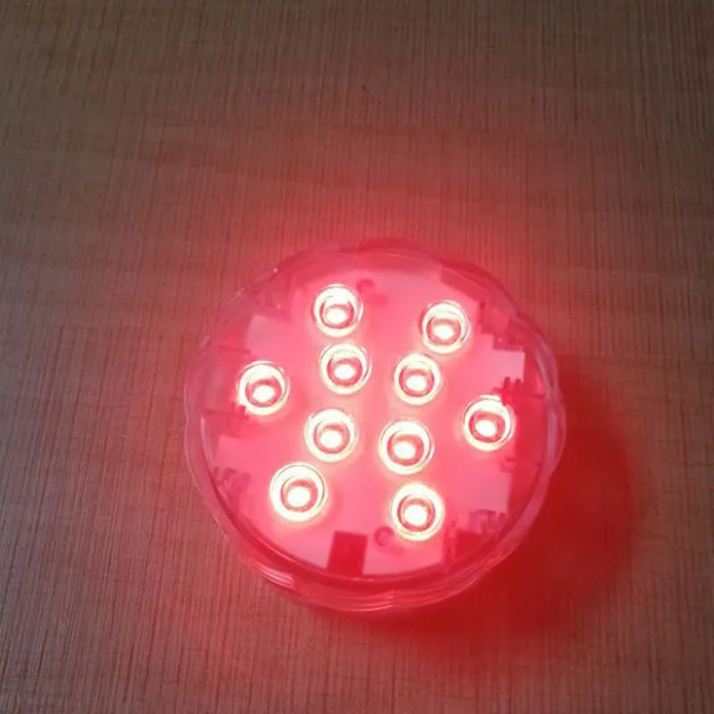 White round waterproof LED light with remote control for pools and ponds.