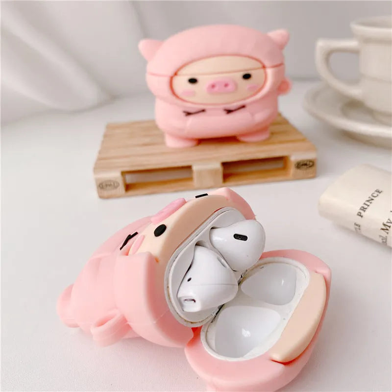 Pink silicone AirPods case cover with cartoon pig design and carrying hook attached