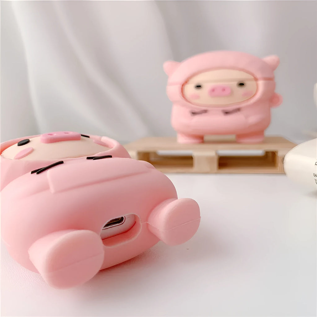 Pink silicone AirPods case cover with cartoon pig design and carrying hook attached