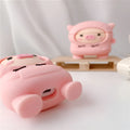 Pink silicone AirPods case cover with cartoon pig design and carrying hook attached