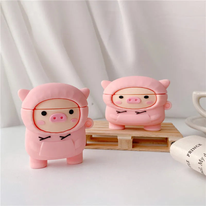 Pink silicone AirPods case cover with cartoon pig design and carrying hook attached