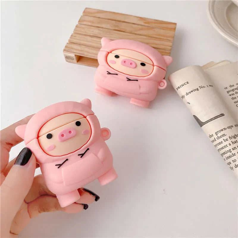 Pink silicone AirPods case cover with cartoon pig design and carrying hook attached