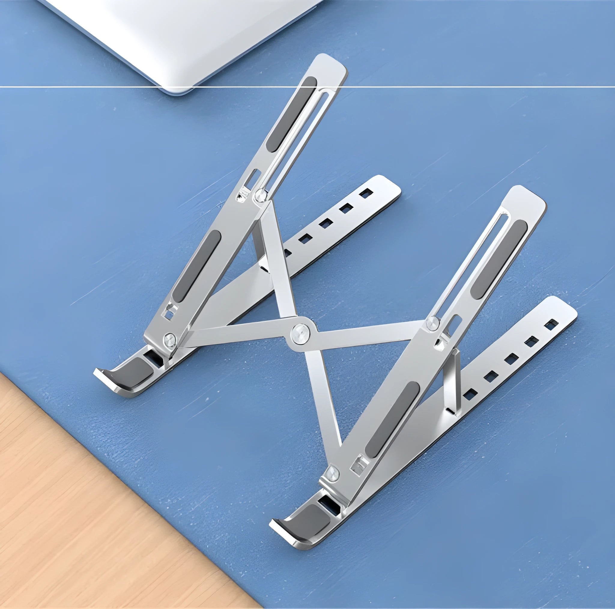 Aluminium alloy folding laptop heightening bracket in black on a desk with a notebook computer placed on top