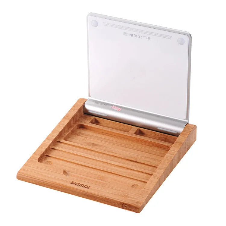 Wooden bamboo bracket for Apple Bluetooth trackpad placed beside an Apple tablet, 15 x 15.8 cm