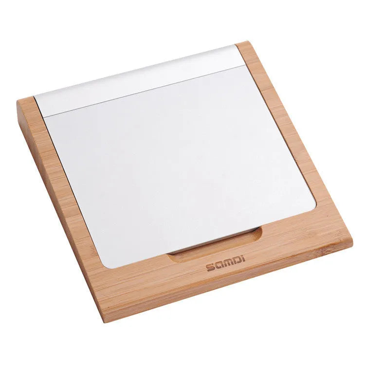 Wooden bamboo bracket for Apple Bluetooth trackpad placed beside an Apple tablet, 15 x 15.8 cm