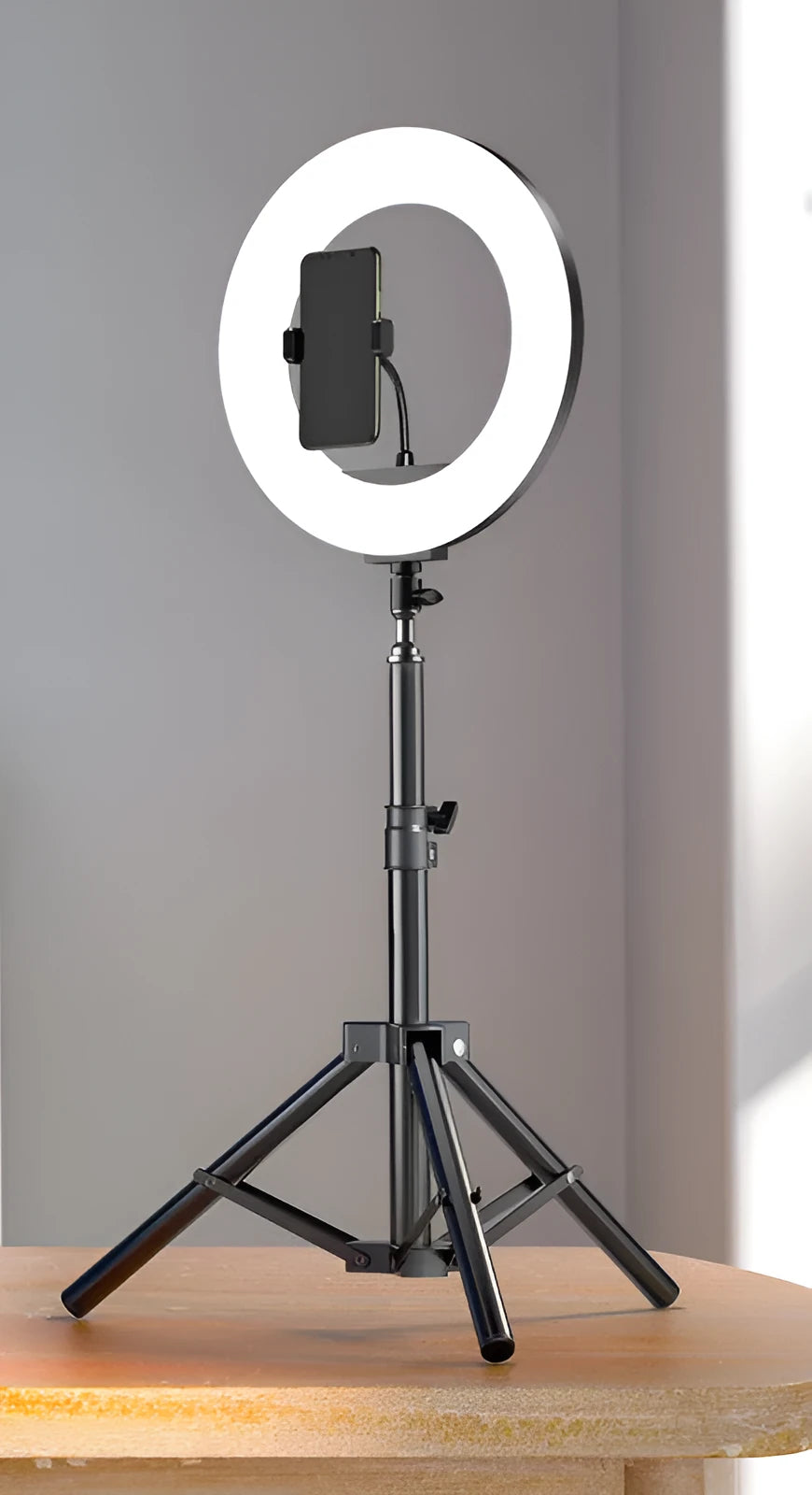 Carbon steel mobile phone tripod with attached light ring, shown at different heights for iPhone content creation