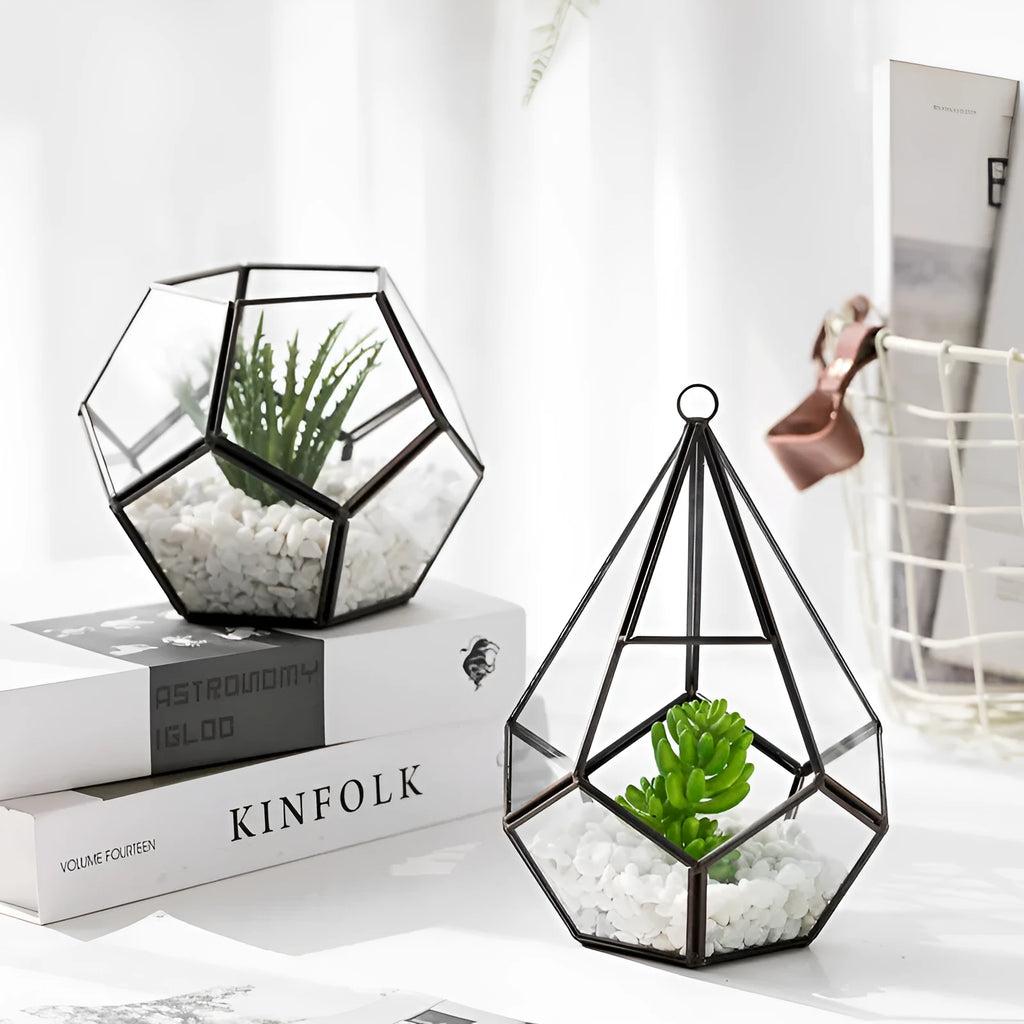 Metal and glass succulent pot decoration in golden love style on a wooden shelf