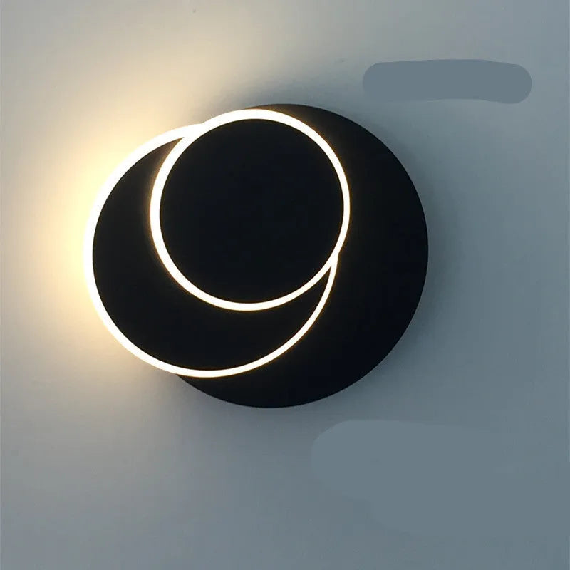 Modern round wall lamp with acrylic shade in black or white finish