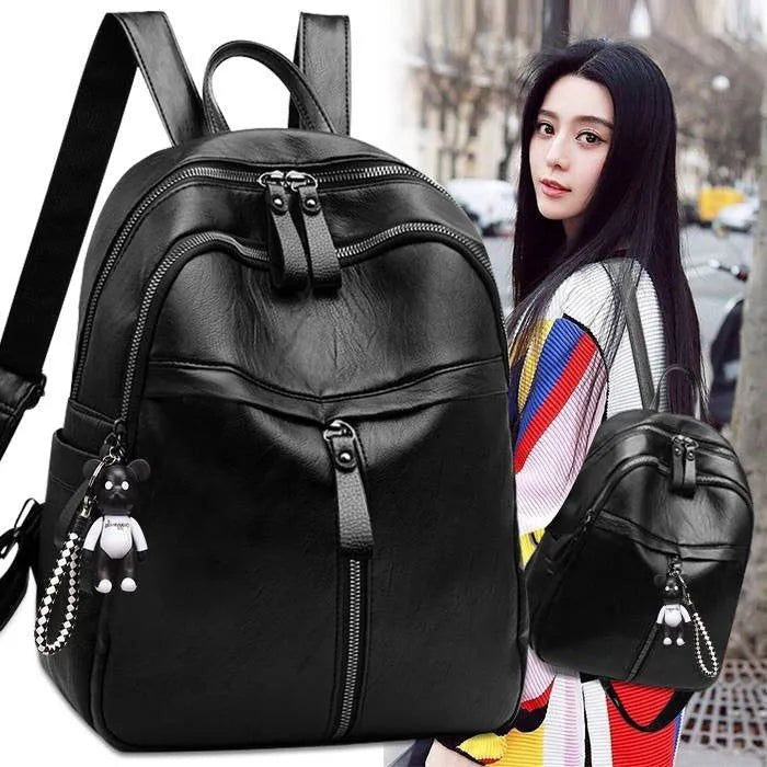 Black PU leather soft surface backpack with double straps showing medium size and organised compartments