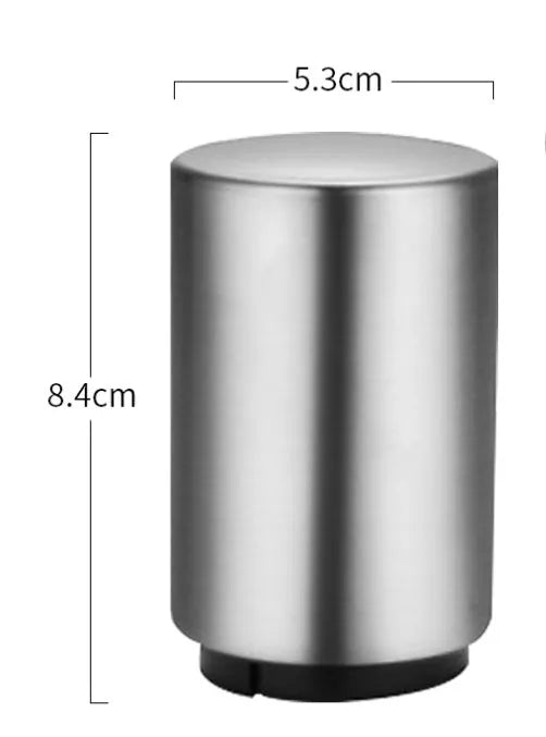 Automatic stainless steel beer bottle opener with magnetic cap catch on a table