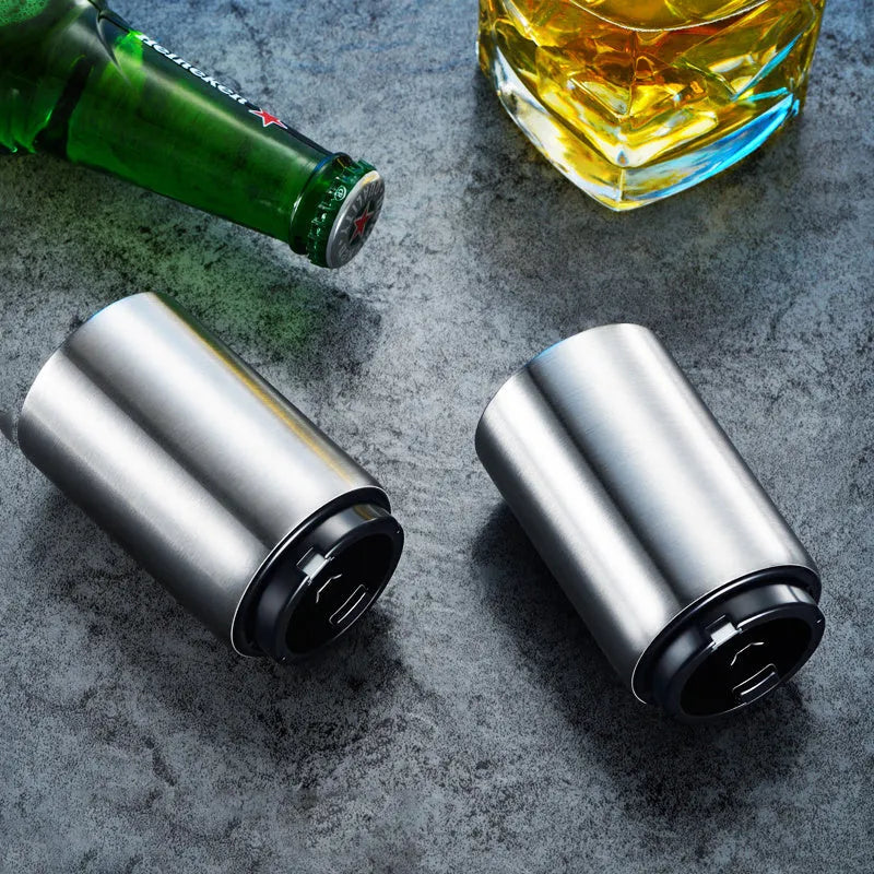 Automatic stainless steel beer bottle opener with magnetic cap catch on a table