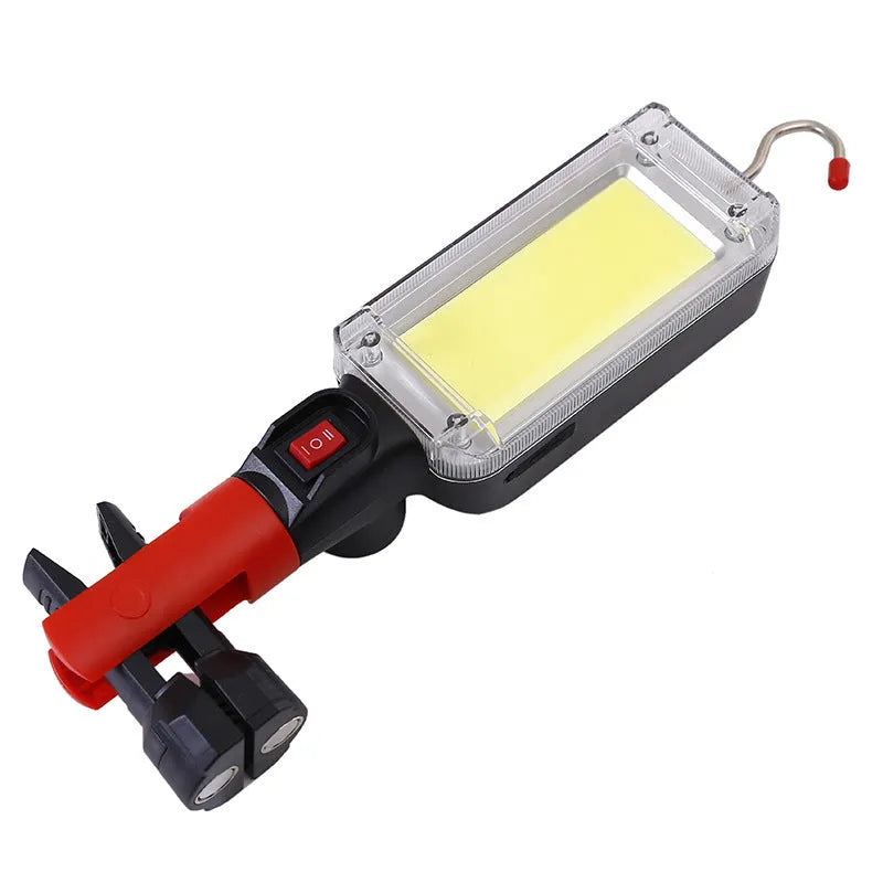 Red portable COB flashlight with magnetic hook showing USB charging port