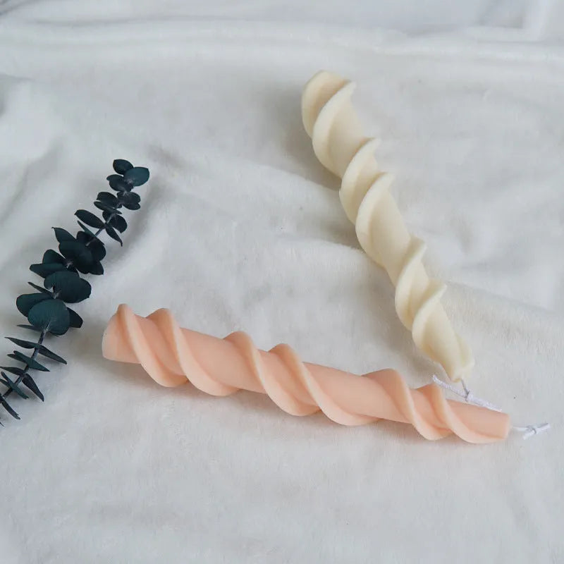 Spiral lace silicone candle mould for creating decorative taper candles with rotating pattern design