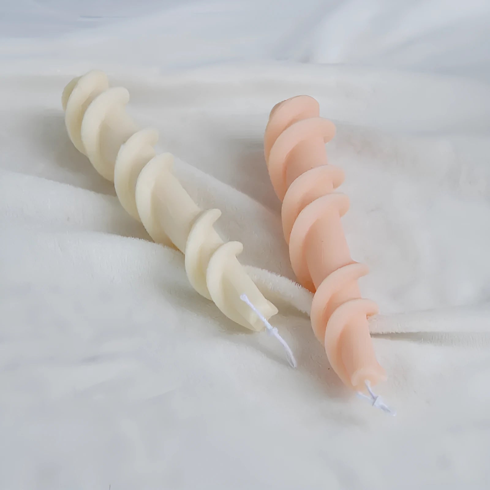 Spiral lace silicone candle mould for creating decorative taper candles with rotating pattern design