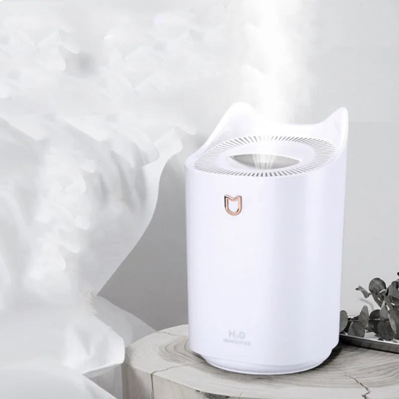 Coral Pink double spray USB humidifier and aroma diffuser with three mist outlets on a wooden table.