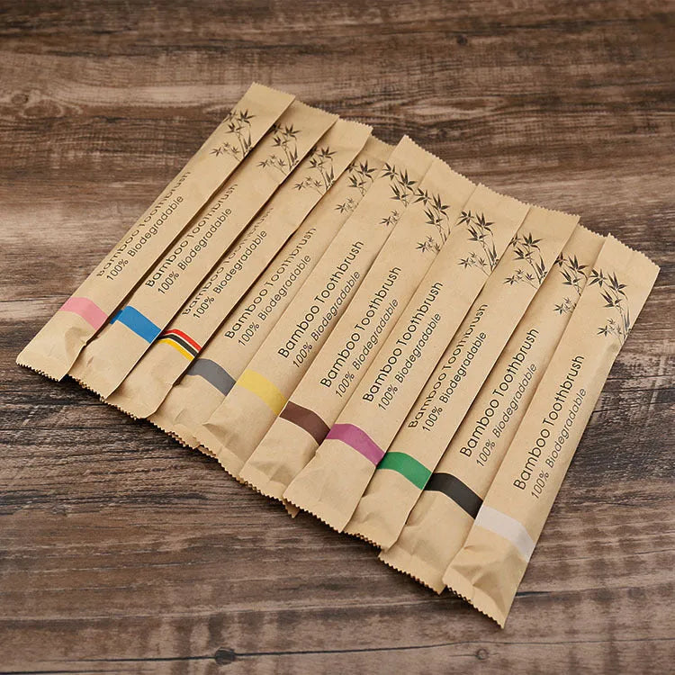 10 bamboo toothbrushes with soft charcoal bristles in assorted colours arranged fanned out