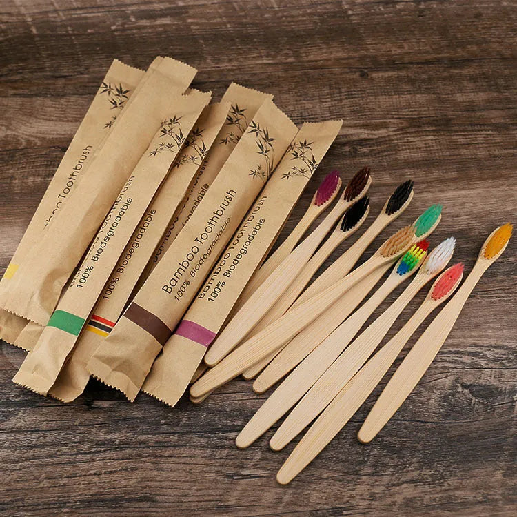 10 bamboo toothbrushes with soft charcoal bristles in assorted colours arranged fanned out