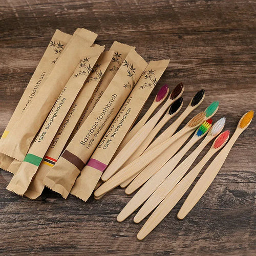 10 bamboo toothbrushes with soft charcoal bristles in assorted colours arranged fanned out