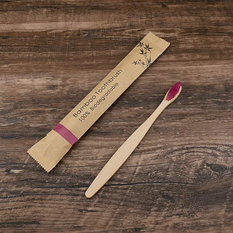 10 bamboo toothbrushes with soft charcoal bristles in assorted colours arranged fanned out