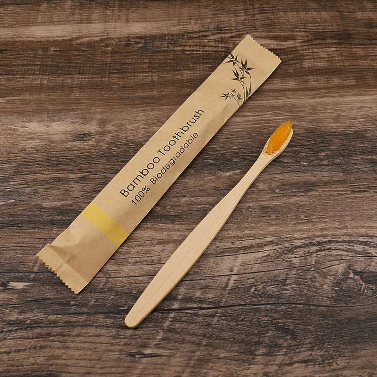 10 bamboo toothbrushes with soft charcoal bristles in assorted colours arranged fanned out