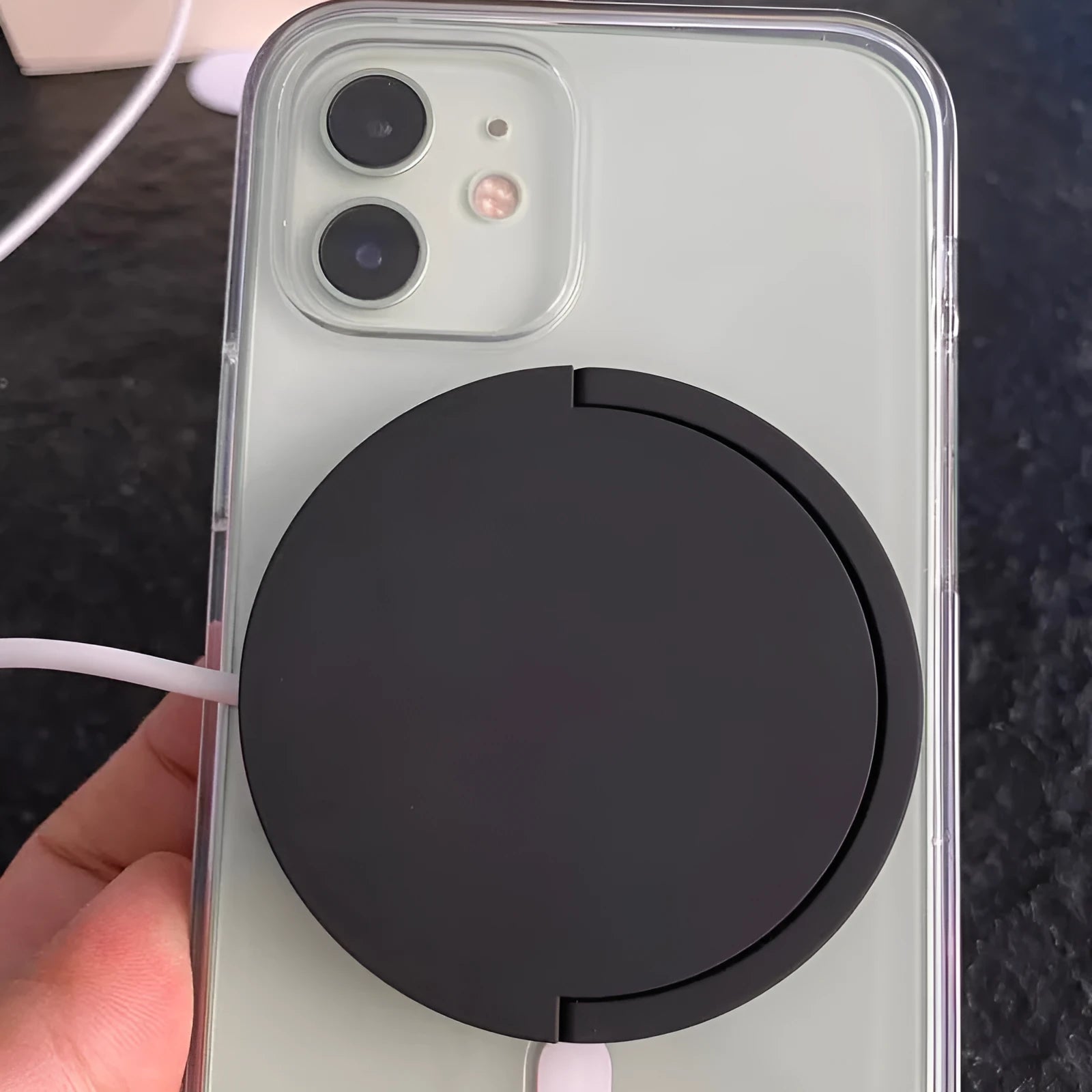 Black magnetic bracket wireless charger with Type-C input on a desk, 15W fast charging device