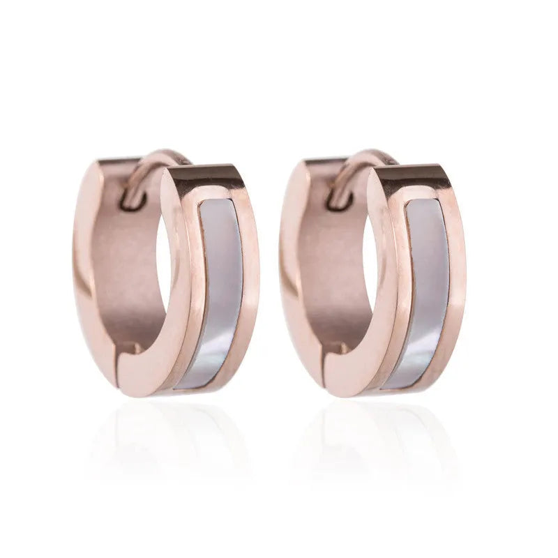 Pair of black titanium steel earrings with geometric shell inlay on white background