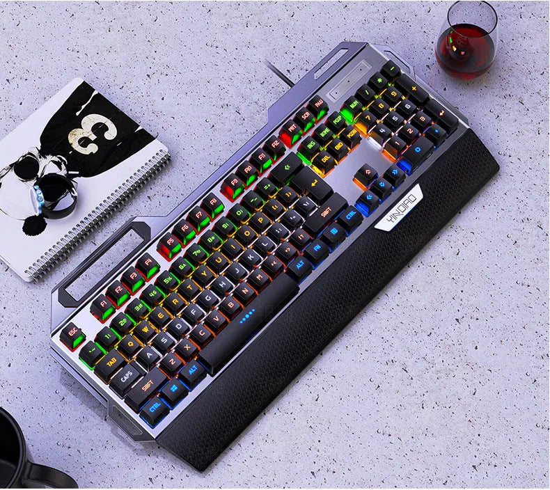 Silver Carving K100 metal mechanical keyboard with black keys and seven-color backlight on a desk