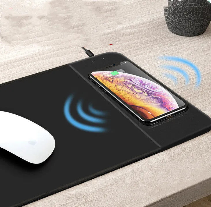 Cartoon design wireless charging mouse pad with RGB lights on a desk