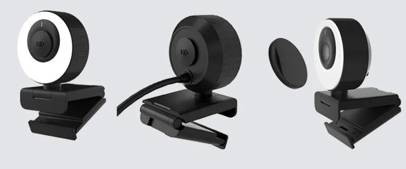 Black USB webcam on a desk with a 1.7m cable, showing a magnetic privacy cover next to the lens.