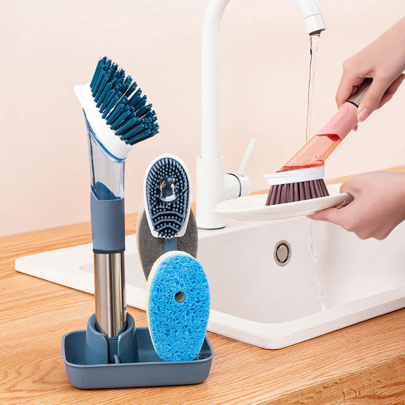 Multifunctional dish brush with soap dispenser, long handle, scouring block and sponge, in blue colour on a kitchen counter