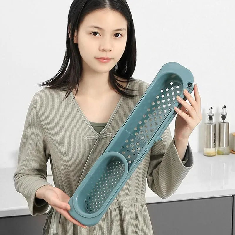 Telescopic sink rack in blue grey with sponge and soap on drainer, bar towel holder attached, stable PP construction