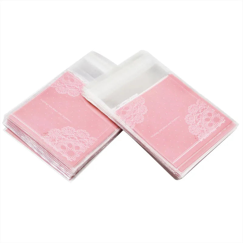 Pink self-adhesive plastic packaging bag with clear window and resealable strip, shown flat and filled.