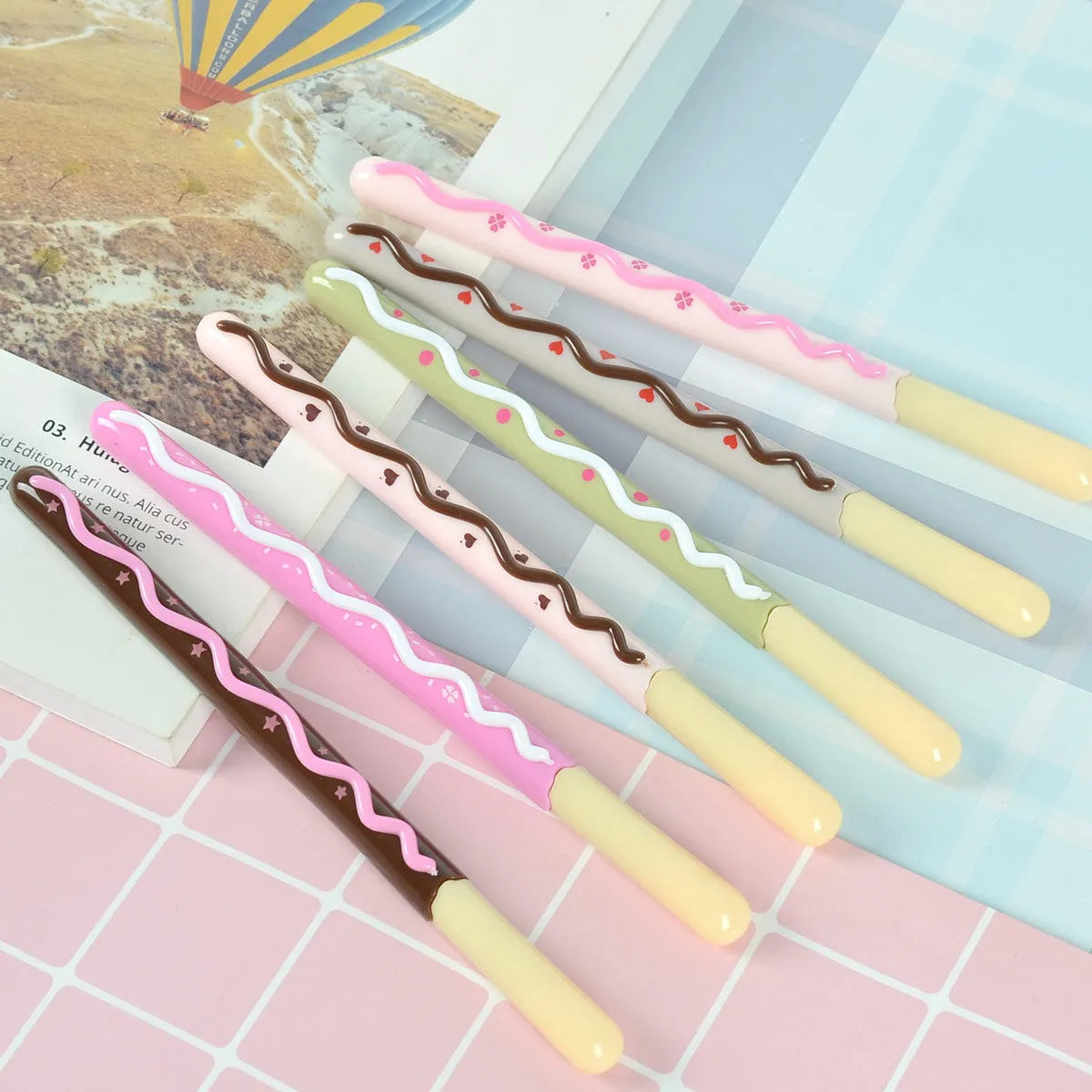 Set of five Korean soft gel chocolate scented needle tube gel pens with black ink, assorted chocolate-themed colours, plastic barrel, cap closure