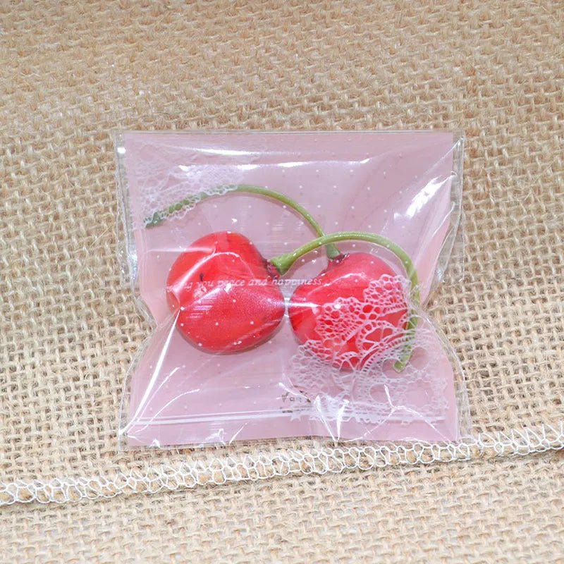 Pink self-adhesive plastic packaging bag with clear window and resealable strip, shown flat and filled.
