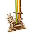 Ukrainian wooden rotating machinery model pen holder on a desk