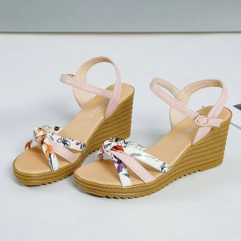 Women's pink wedge sandals with thick heel, fish mouth front, and buckle closure on non-slip sole