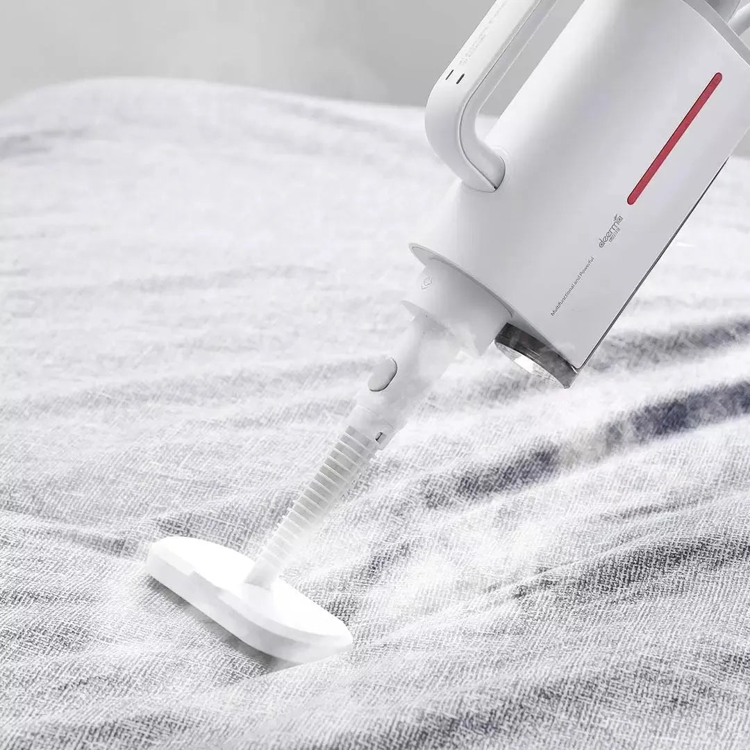 Deerma ZQ610 white steam cleaner with five brush heads, glass scraper, and corrugated pipe on a light background