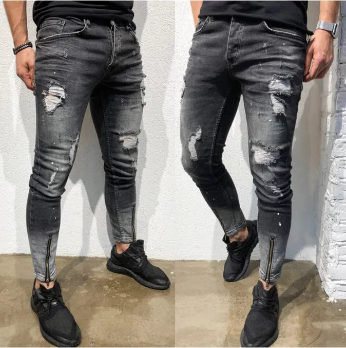 Men's black ripped denim jeans with zipper and elasticated ankle cuffs, shown flat on surface.