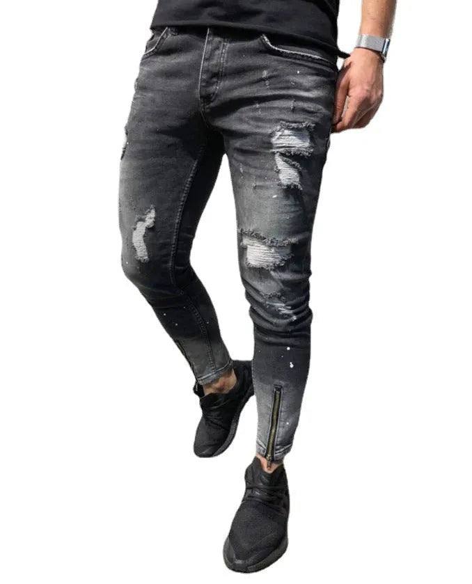 Men's black ripped denim jeans with zipper and elasticated ankle cuffs, shown flat on surface.