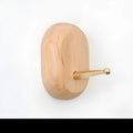 Perforated beech wood wall hook with brass component in modern capsule shape design