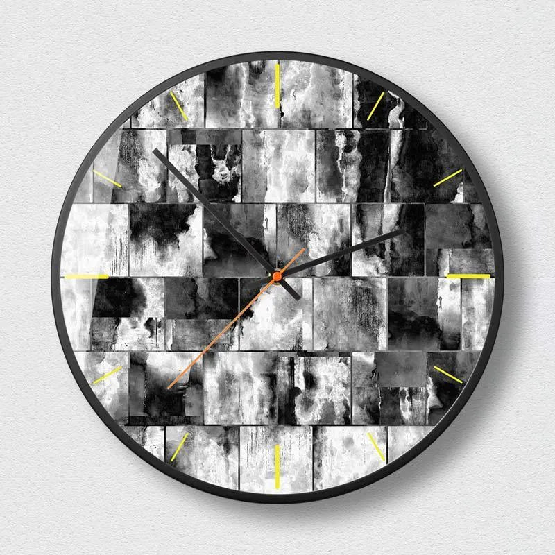 Round abstract art wall clock in black on a wall, showing hour and minute hands