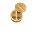 Bamboo seasoning box with a small spoon next to it on a kitchen countertop
