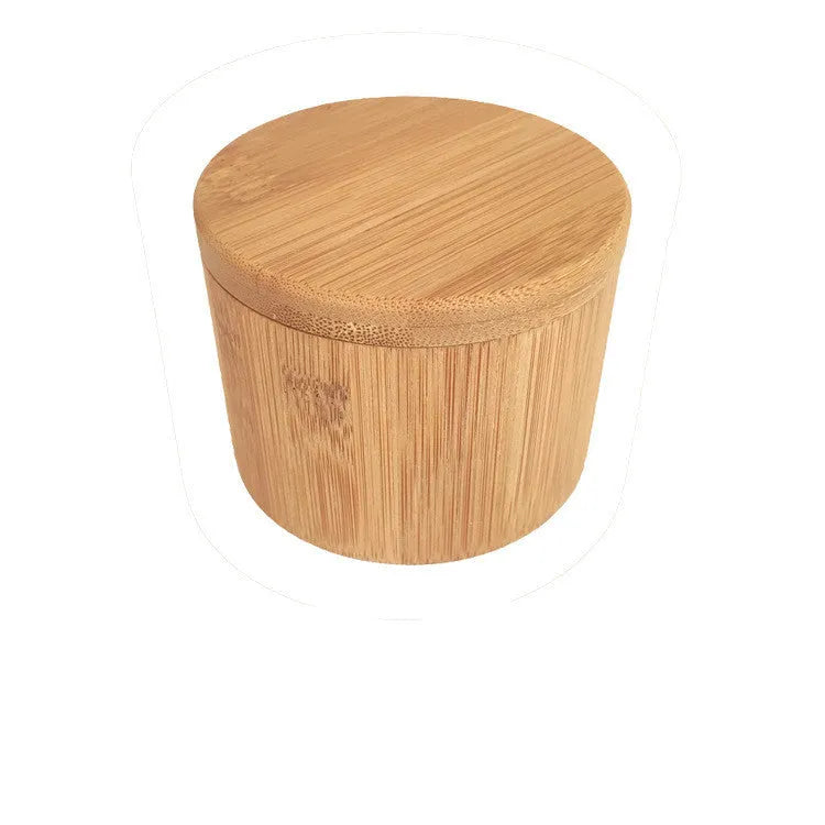 Bamboo seasoning box with a small spoon next to it on a kitchen countertop