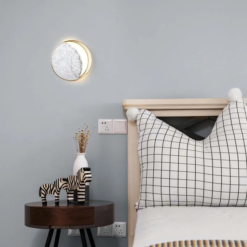 Round marble and copper LED wall lamp with eclipse art design, 25cm diameter, mounted on wall with push button switch