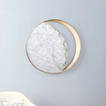 Round marble and copper LED wall lamp with eclipse art design, 25cm diameter, mounted on wall with push button switch