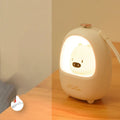 Cartoon bedside night light with touch dimming and LED soft glow on a table