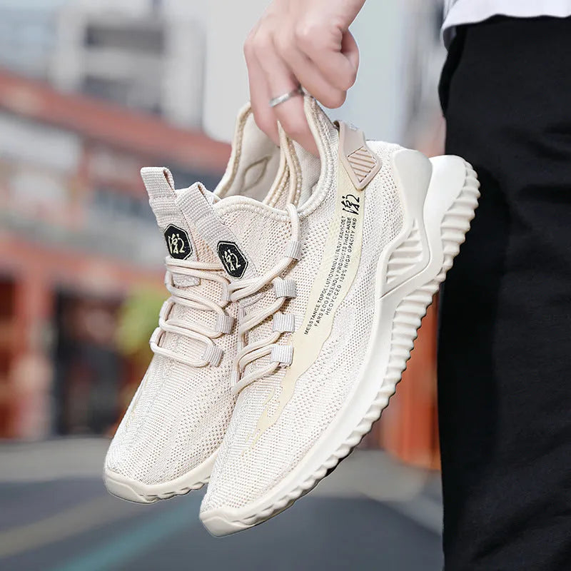 Men's white mesh sports shoes with rubber sole and lace-up front on grey background