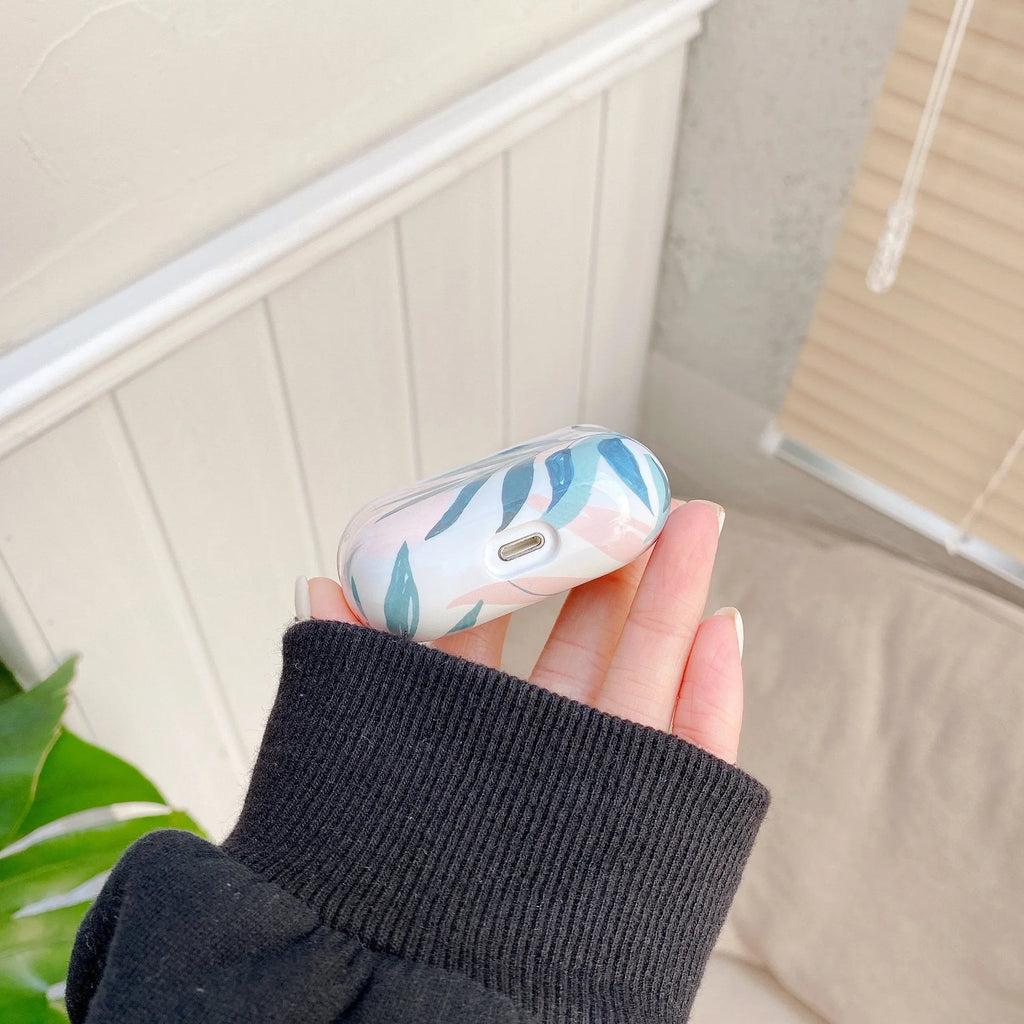 Soft blue TPU AirPods case with painted tropical banana leaf design.