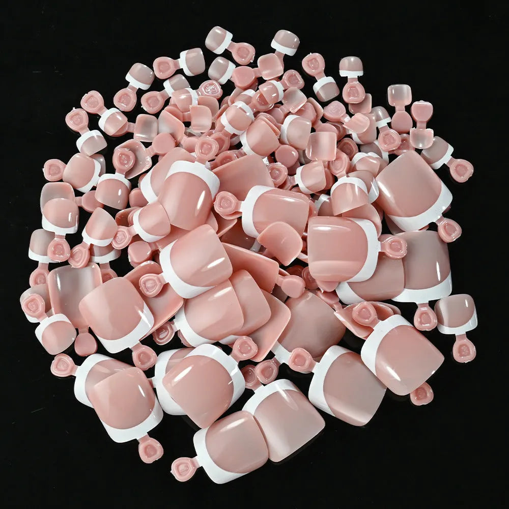 Box of 120 French white edge nude square short toe nail pieces in nine shades.