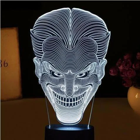 USB-powered 3D acrylic LED lamp showing colour gradient effect, with remote control and base on a desk.